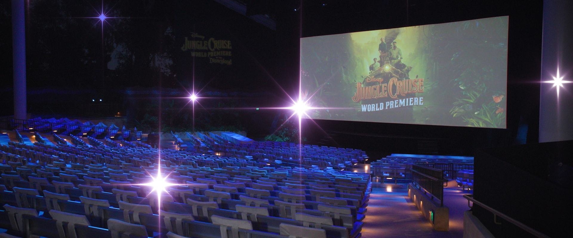 A large screen showing Disney's Jungle Cruise movie title in an empty theater