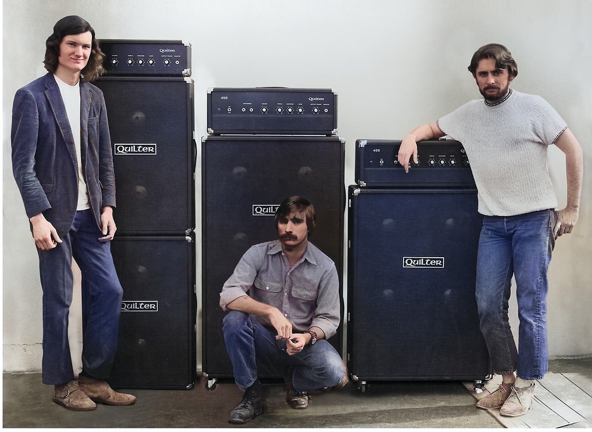 Three QSC founders at Quilter, Barry Andrews, and John Andrews,  posing with their quilter guitar amplifier products in a studio setting.