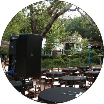 Image of a QSC speaker pointing toward tables